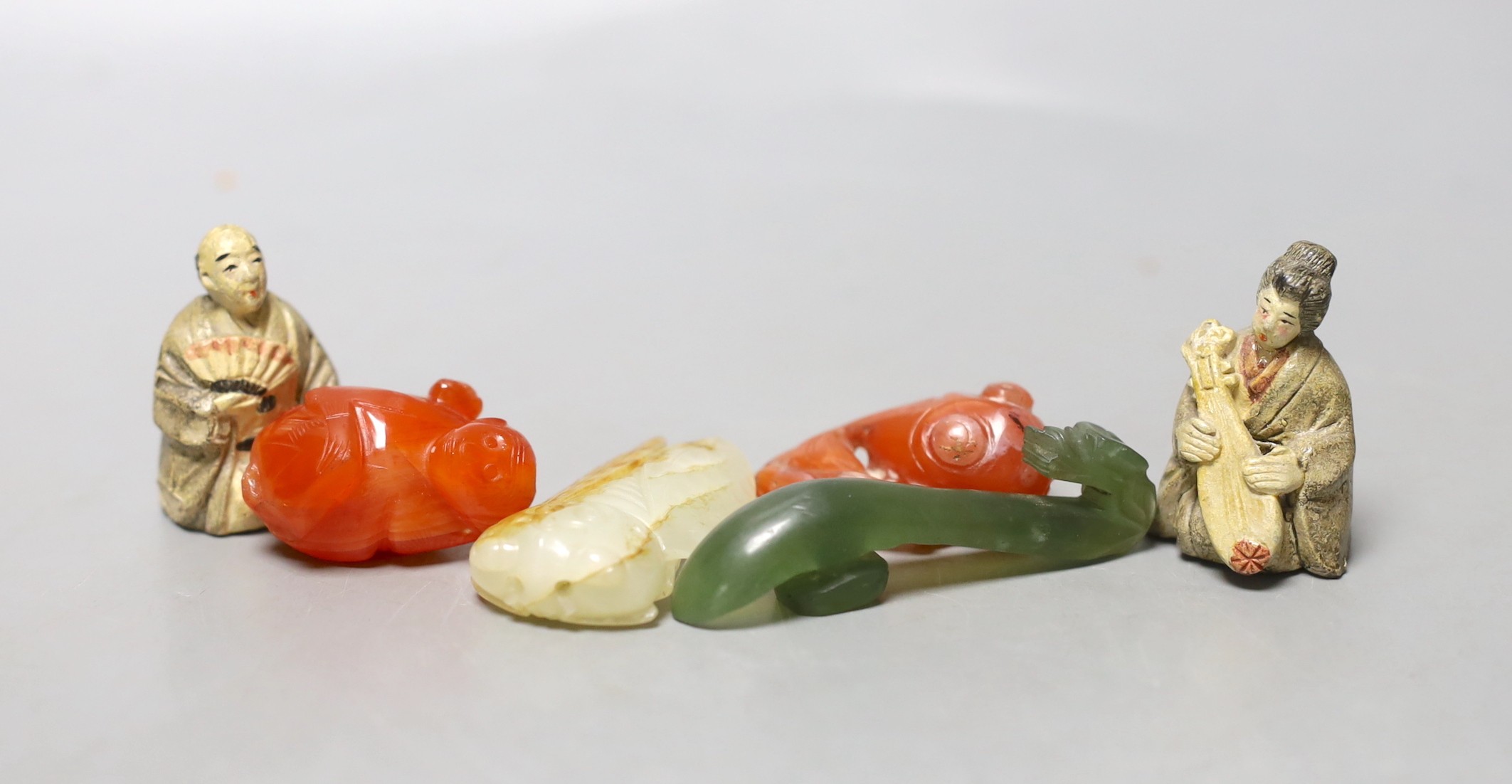 A 19th century Chinese pale celadon and russet jade carving of a cicada, 4.9cm, together with three other hard stone figures and two Japanese earthenware figures (6)